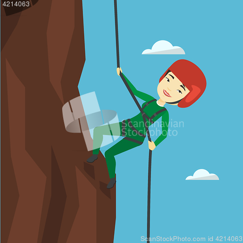 Image of Woman climbing in mountains with rope.