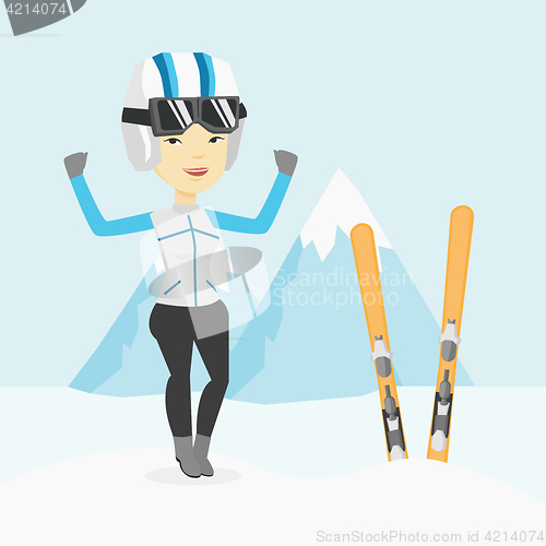 Image of Cheerful skier standing with raised hands.