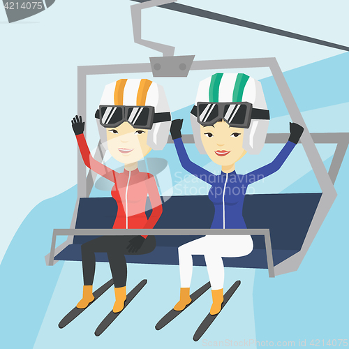 Image of Two happy skiers using cableway at ski resort.