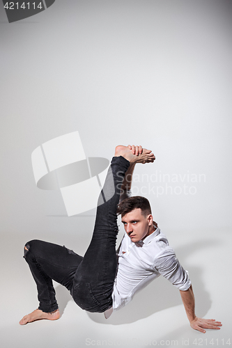 Image of The young man dancing on gray