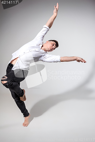 Image of The young man dancing on gray