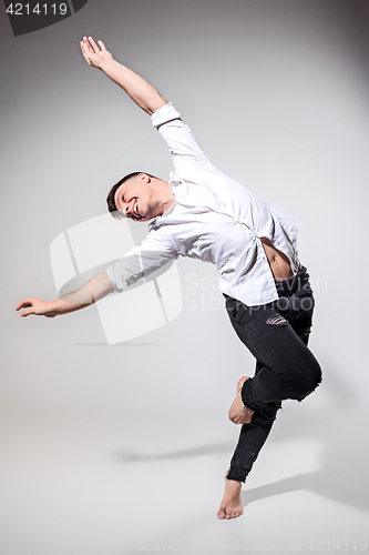 Image of The young man dancing on gray