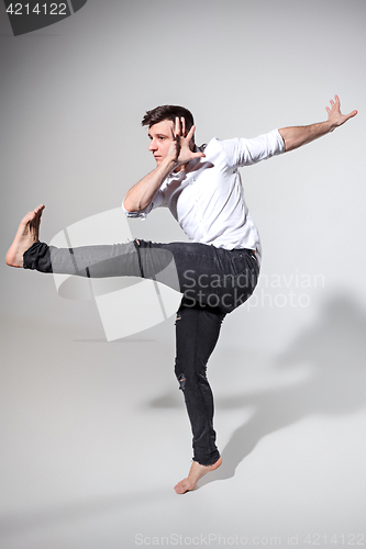 Image of The young man dancing on gray