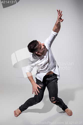 Image of The young man dancing on gray