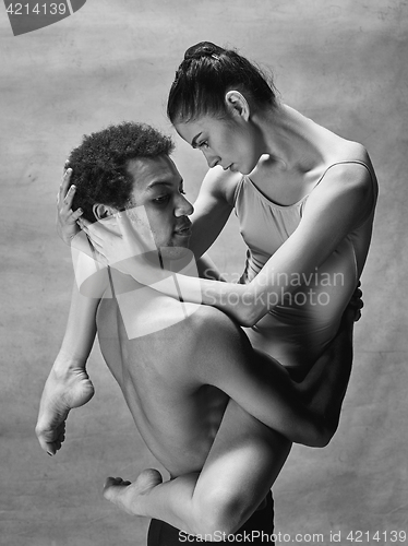 Image of Couple of ballet dancers posing over gray background