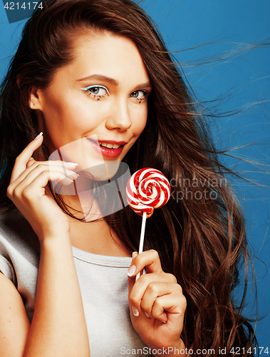 Image of young pretty adorable woman with candy close up like doll