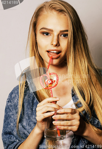 Image of young blond woman on white backgroung gesture thumbs up, isolate