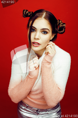 Image of young pretty emitonal posing teenage girl on bright red background, happy smiling lifestyle people concept 