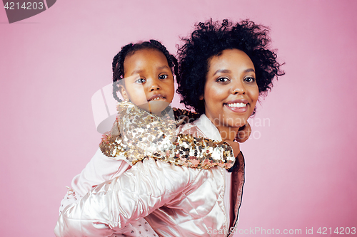 Image of young pretty african-american mother with little cute daughter hugging, happy smiling on pink background, lifestyle modern people concept 