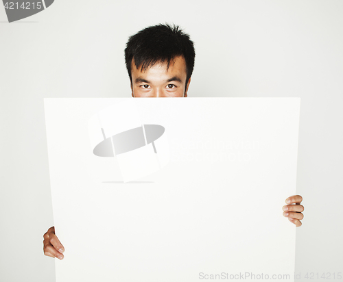 Image of pretty cool asian man holding empty white plate smiling