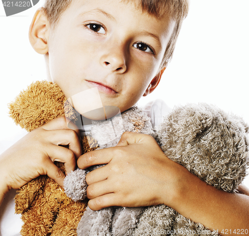 Image of little cute boy with many teddy bears hugging isolated close up