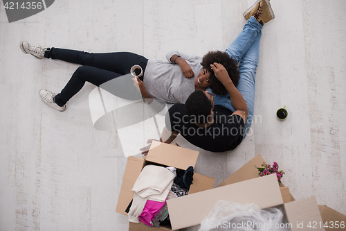 Image of African American couple relaxing in new house