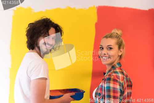 Image of couple painting interior wall