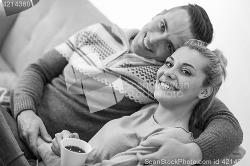 Image of Young couple  in front of fireplace