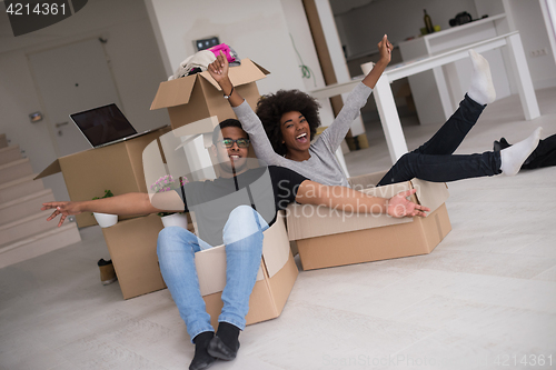 Image of African American couple  playing with packing material