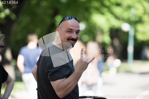 Image of man showing a rock hand gesture