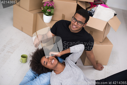 Image of African American couple relaxing in new house