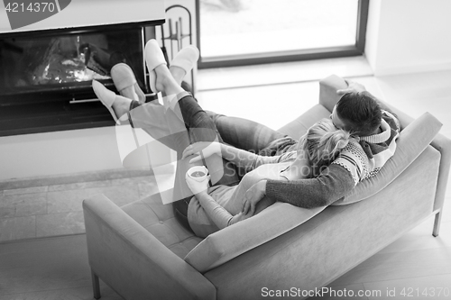 Image of Young couple  in front of fireplace