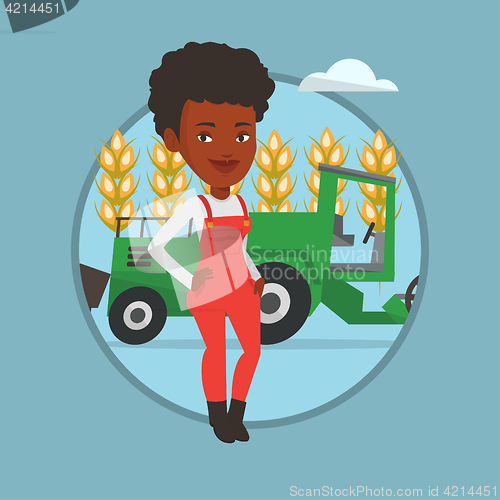 Image of Farmer standing with combine on background.