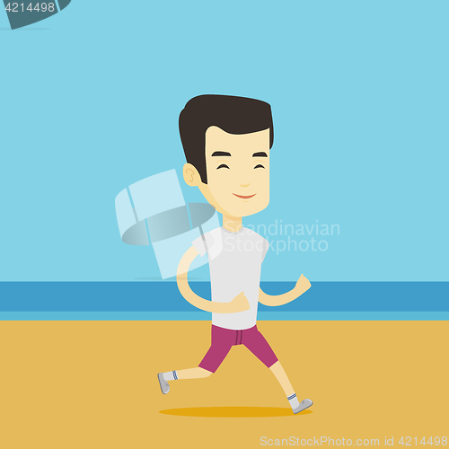 Image of Young sporty man jogging on the beach.