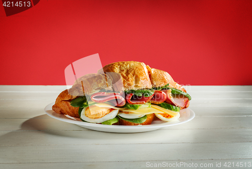 Image of Croissants sandwiches on the wooden cutting board