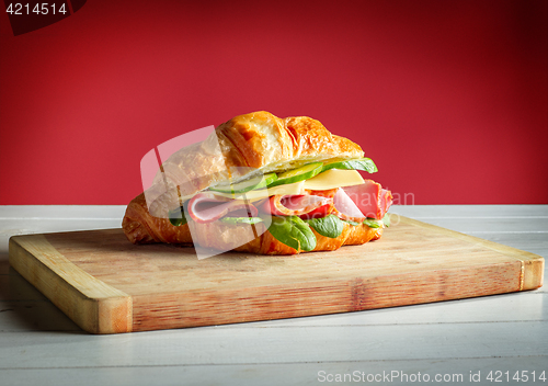 Image of Croissants sandwiches on the wooden cutting board