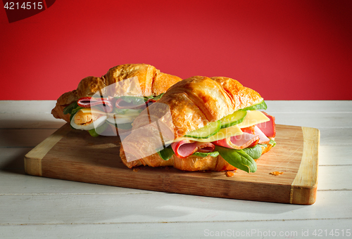 Image of Croissants sandwiches on the wooden cutting board