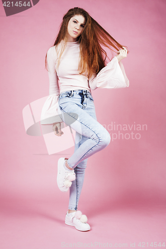 Image of young pretty red hair ginger girl jumping isolated on pink background, lifestyle flying teen people happy smiling concept 