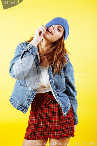 Image of lifestyle people concept: pretty young school teenage girl having fun happy smiling on yellow background