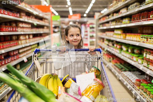 Image of girl with food in shopping cart at grocery store