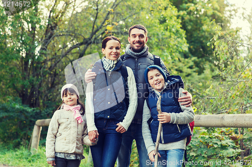 Image of happy family with backpacks hiking