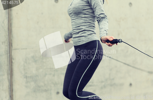 Image of close up of woman exercising with jump-rope