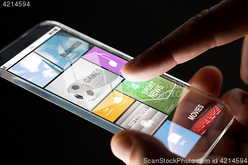 Image of close up of hand with apps on smartphone