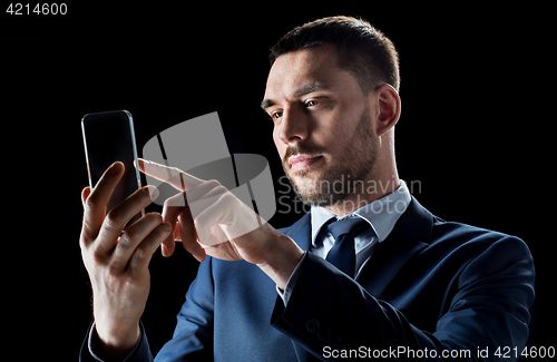 Image of businessman with transparent smartphone