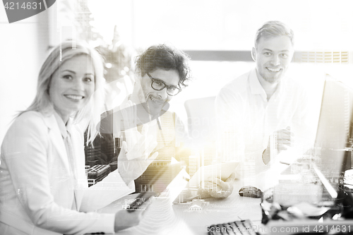 Image of happy business team with tablet pc at office