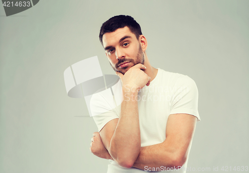 Image of man thinking over gray background