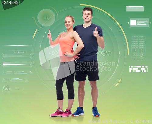 Image of happy sportive man and woman showing thumbs up