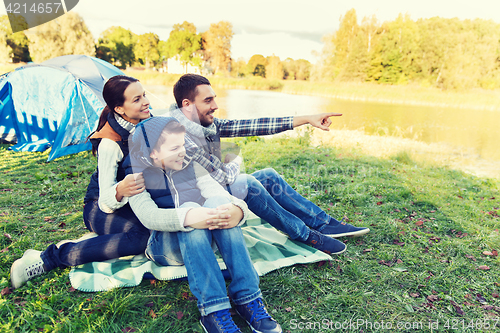 Image of happy family with tent at camp site