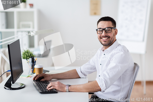 Image of businessman typing on computer keyboard at office