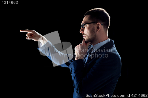 Image of businessman in suit over black