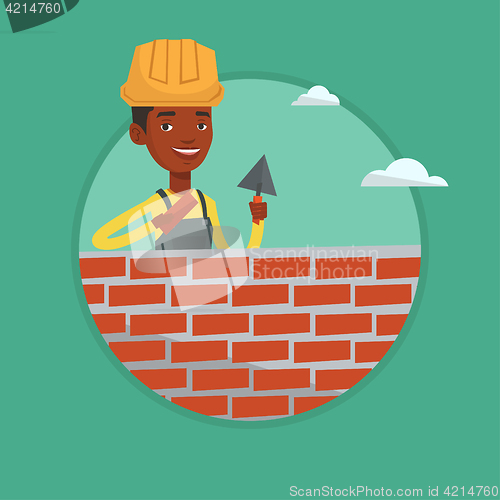 Image of Bricklayer working with spatula and brick.