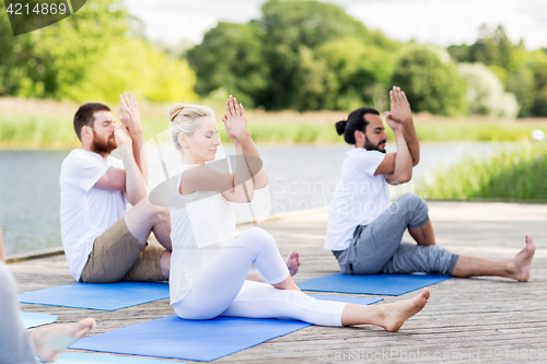 Image of people making yoga and meditating outdoors