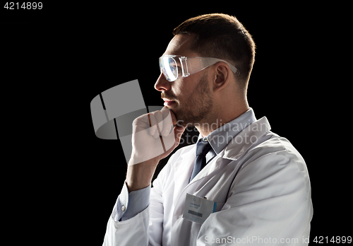 Image of doctor or scientist in lab coat and safety glasses