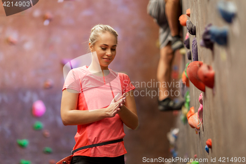 Image of young woman exercising at indoor climbing gym wall