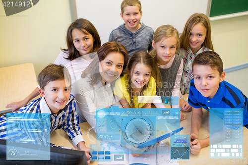 Image of group of kids with teacher and tablet pc at school
