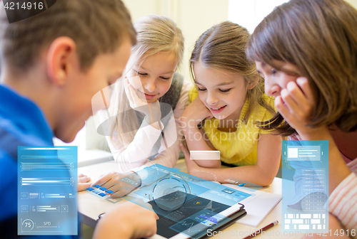 Image of group of school kids with tablet pc in classroom