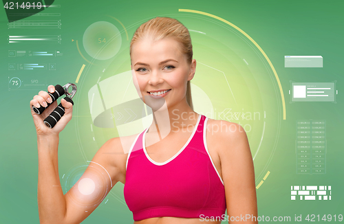 Image of sporty woman with expander over green background