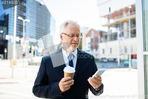 Image of businessman with smartphone and coffee in city