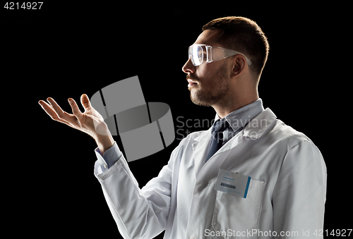 Image of doctor or scientist in lab coat and safety glasses