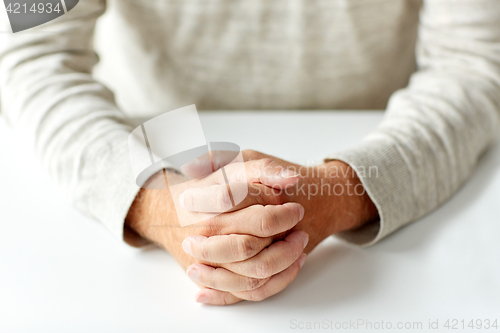 Image of close up of senior man hands on table